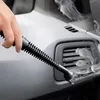A hand is using a steam cleaner to clean the air vents of a car interior. Náhled obrázku produktu