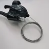 A black bicycle gear shifter with a coiled cable on a white background. Anteprima dell’immagine prodotto