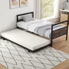 A bedroom scene with a twin bed and a pull-out trundle bed on a rug. Náhled obrázku produktu
