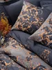 A close-up view of a dark blue and gray satin duvet cover set with a gold baroque pattern. Podgląd zdjęcia produktu