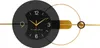 A modern wall clock with a black and gold abstract design. Anteprima dell’immagine prodotto