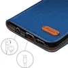 A close-up view of a blue flip phone case, showing the ports and a leather tag with a logo. Produktbild-Vorschau