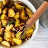 A close-up of roasted potatoes with a fork in the foreground. Produktbild-Vorschau