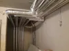 Insulated pipes in a building's utility area. Produktbild-Vorschau