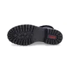 The sole of a black boot is shown against a white background. Voir les images du produit