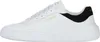 A white Skechers sneaker with black and gold accents is shown from the side. Náhled obrázku produktu
