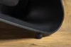 A close-up of a black product leg resting on a wooden surface. Produktbild-Vorschau