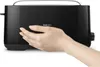 A hand is shown touching the side of a black toaster. Produktbild-Vorschau
