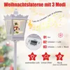A white Christmas lantern with a snowman inside, set against a blurred festive background with musical notes and text overlays describing its features. Produktbild-Vorschau