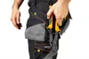 A person's hand is shown reaching into a tool pocket on work pants, holding a pair of pliers. Anteprima dell’immagine prodotto