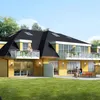 A modern yellow brick house with balconies and a garden. Produktbild-Vorschau