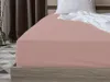 A close-up view of a bed with a fitted sheet. Produktbild-Vorschau