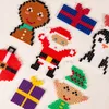 A collection of Christmas-themed crafts made from colorful beads, arranged on a white surface. Produktbild-Vorschau