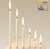 Several white candles of varying heights are burning on a light-colored surface. Produktbild-Vorschau