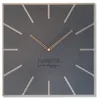 A square wall clock with a dark gray face and light gray hour markers. Rose gold hands point to approximately 10:10. Text is visible in the center of the clock face. Anteprima dell’immagine prodotto