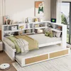 A bedroom scene featuring a white daybed with a pull-out trundle, integrated shelving, and decorative items.