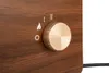 A close-up view of a control knob and symbols on a wood-grain textured surface. Náhled obrázku produktu