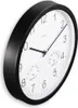 A close-up, angled view of a black-framed wall clock with a white face, showing the time and integrated thermometer and hygrometer. Anteprima dell’immagine prodotto