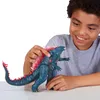 A young boy is playing with a Godzilla toy. Produktbild-Vorschau
