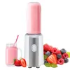 A portable blender with a full bottle of pink smoothie, a glass of smoothie, and a pile of fresh berries. Produktbild-Vorschau