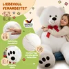 A girl hugging a large white teddy bear, with various feature callouts and German text. Anteprima dell’immagine prodotto