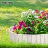 A close-up of a garden border made of white wooden planks, filled with colorful flowers and greenery. Produktbild-Vorschau