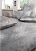 A bedroom setting with bedding and pillows. Produktbild-Vorschau