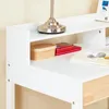 A close-up view of a white desk with a lamp and some items on it. Podgląd zdjęcia produktu