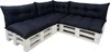 A sectional sofa made of white wooden pallets with dark blue cushions.
