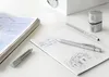 A desk with architectural drawings, pens, and an eraser. Produktbild-Vorschau