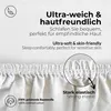 Close-up of a white fabric with text overlays describing its features. Produktbild-Vorschau