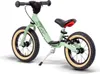 A light green balance bike with black handlebars and seat, and tan tires, is shown against a white background. Produktbild-Vorschau