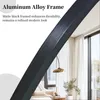A close-up of a black aluminum frame, with text overlay describing its features, and a blurred background of a modern living room. Produktbild-Vorschau
