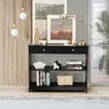 A black console table with items on and in it, placed in a room with wooden walls and a rug. Produktbild-Vorschau