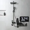 A modern black shower system with a digital temperature display mounted on a tiled wall. Náhled obrázku produktu