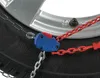 A close-up of a snow chain attached to a car tire and wheel. Produktbild-Vorschau