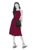 A mannequin wearing a dress and a shoulder bag. Produktbild-Vorschau