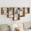 A wall-mounted shelf unit with various decorative items and books, placed above a couch. Produktbild-Vorschau