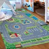 A colorful children's play rug depicting a city street scene with roads, buildings, and a playground. Produktbild-Vorschau