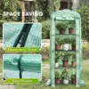 A green four-tier greenhouse with plants on shelves, set up outdoors on grass. Voir les images du produit