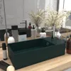 A dark green ceramic bathroom sink is displayed on a wooden countertop, surrounded by various toiletries and decorative items. Podgląd zdjęcia produktu