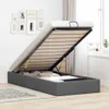 A dark gray ottoman bed with the mattress base lifted to reveal storage space underneath. Podgląd zdjęcia produktu
