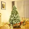 A decorated Christmas tree with presents and festive decorations in a room. Podgląd zdjęcia produktu