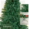 A close-up view of a green artificial Christmas tree with decorative elements and text overlays highlighting features. Náhled obrázku produktu