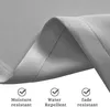 A close-up of gray fabric, likely a curtain, with text overlays describing its features. Voir les images du produit
