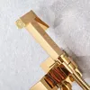A close-up shot of a gold-colored bidet sprayer and its holder, mounted on a textured gray wall. Produktbild-Vorschau