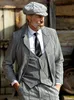 A man in a vintage suit and cap stands in front of a wooden wall. Produktbild-Vorschau