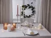 A table setting with candles and wine glasses, suggesting a romantic or festive occasion. Produktbild-Vorschau