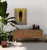 A wooden sideboard with decorative items and plants in a well-lit room. Produktbild-Vorschau