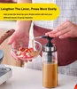 A person is using a sauce dispenser to add sauce to a bowl of chopped ingredients. Produktbild-Vorschau